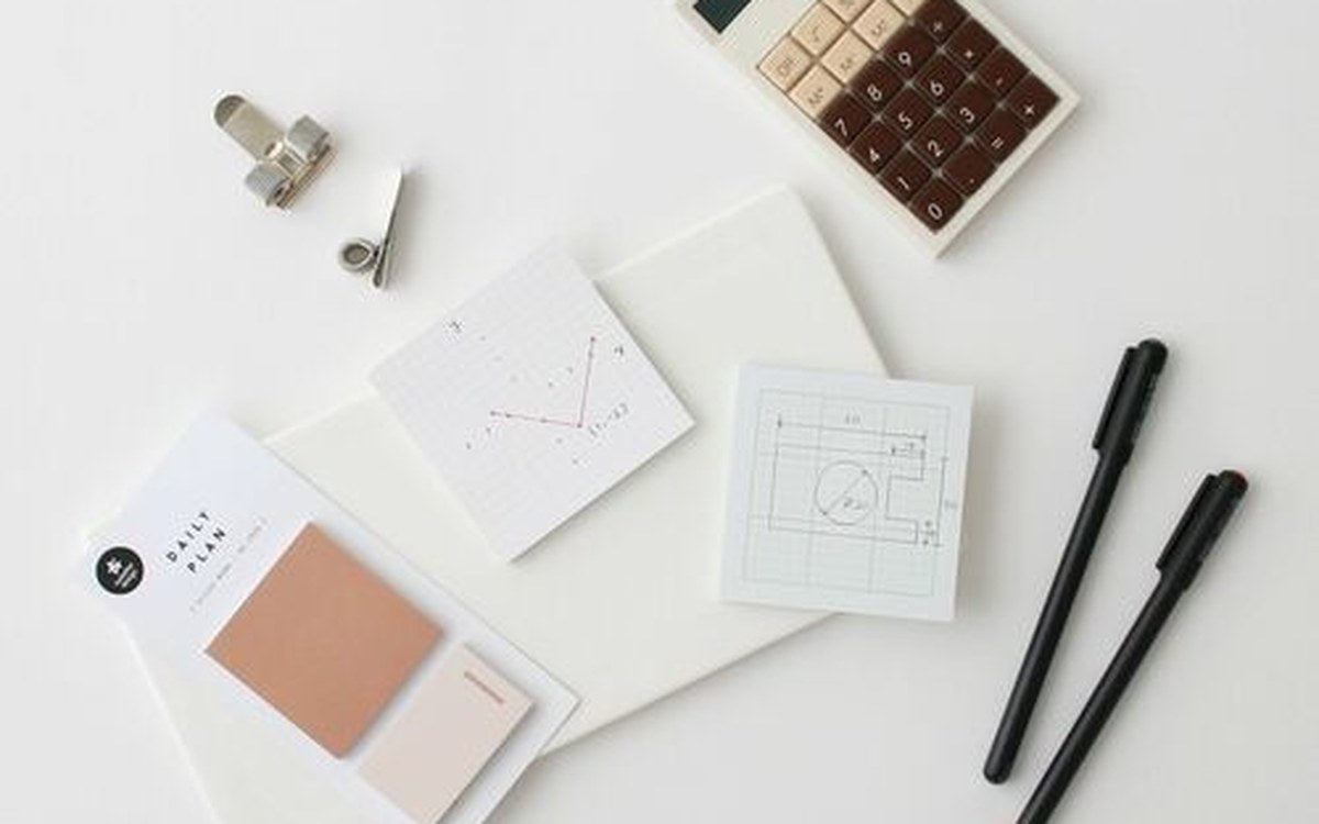 Printed guide pages and covers spread on beige linen